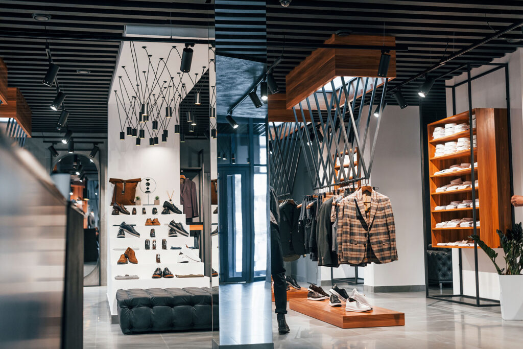 Stylish new clothes in modern store. Elegant expensive wear for men